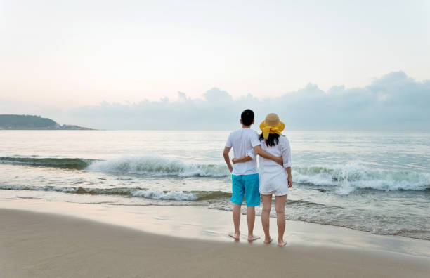 Couple standing on the beach.