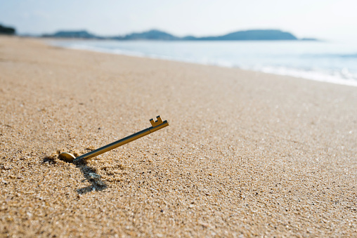 Old key in the sand.