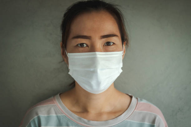istock Asian woman wearing protective hygiene mask 1219750202