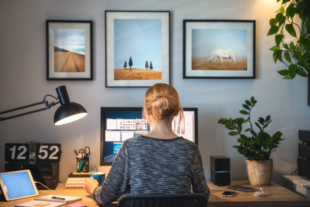 Working From Home Woman working on computer in her home office during pandemic quarantine. freelance work stock pictures, royalty-free photos & images