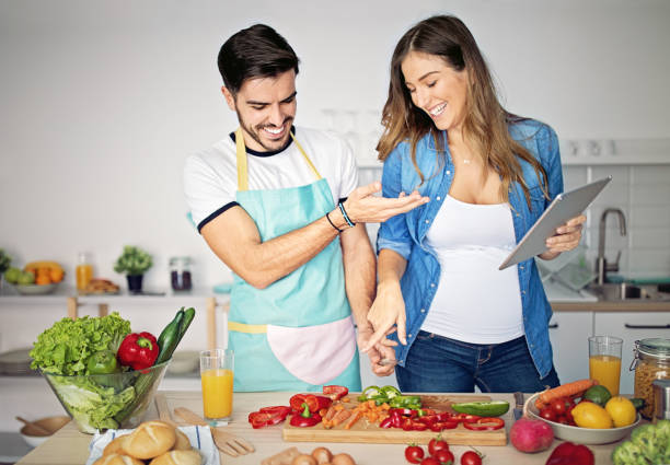 istock Happy couple is cooking in a kitchen 1219751153