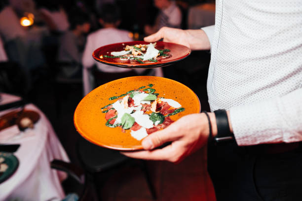 istock the waiter carries snacks on two plates 1219753468