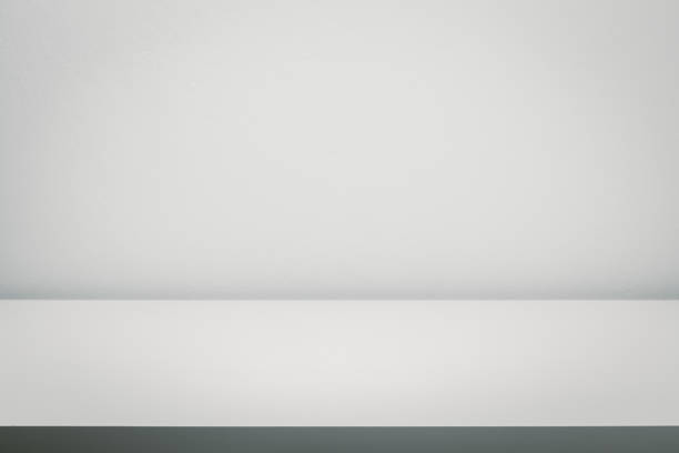 istock Empty white table top, counter, desk over white wall background for product display mockup, template 1219754988