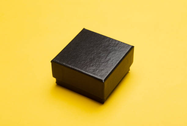 istock Mini black box product packaging isolated on yellow background 1219754994
