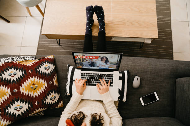 istock Young woman watching a school lesson on her laptop 1219757029