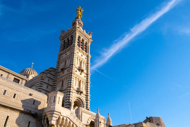 Exterior view of the basilica of Notre Dame de la Garde basilica in Marseille. This neo-Byzantine-style temple was built in the second half of the 19th century on top of a hill, 150 meters above sea level. The basilica, today an important tourist enclave of the city, is dedicated to Our Lady of the Guard, patron saint of sailors and fishermen.