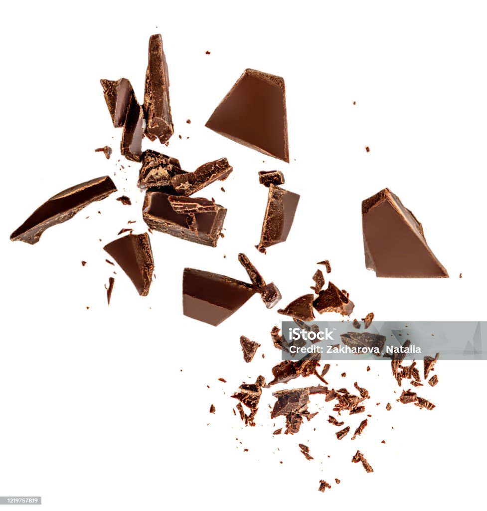 Flying Dark chocolate pieces isolated on white background.  Chocolate bar chunks, shavings and cocoa crumbs Top view. Flat lay Chocolate Stock Photo