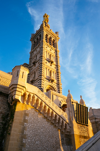 Exterior view of the basilica of Notre Dame de la Garde basilica in Marseille. This neo-Byzantine-style temple was built in the second half of the 19th century on top of a hill, 150 meters above sea level. The basilica, today an important tourist enclave of the city, is dedicated to Our Lady of the Guard, patron saint of sailors and fishermen.