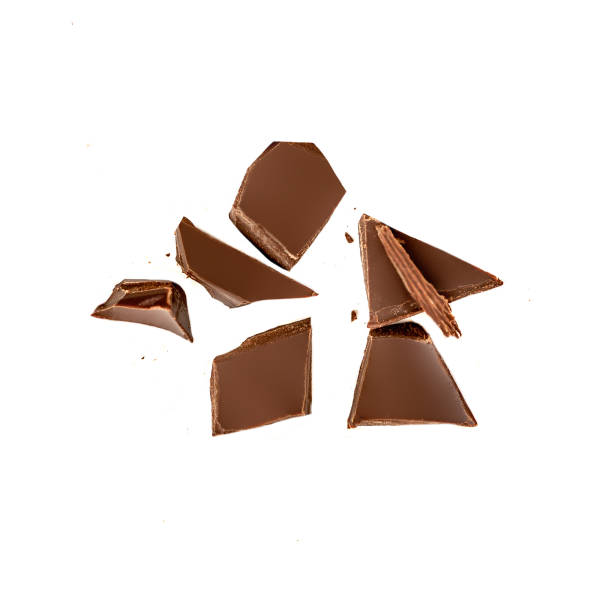 istock Dark chocolate pieces isolated on white background.  Chocolate bar chunks, shavings and cocoa crumbs Top view. 1219757865