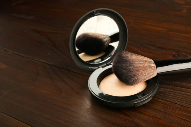istock makeup brushes and face powder on wooden background 1219758218