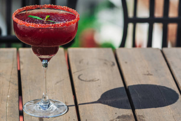 istock Raspberry Margarita in chilled glass over light background on reflection surface, garnished with fresh mint. Most popular cocktails series. 1219758770