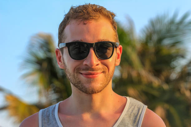 istock young handsome bearded guy in black sunglasses close up 1219760490