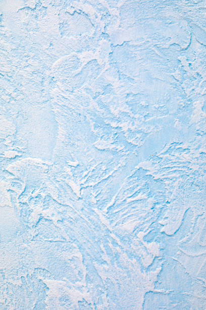 istock The relief blue wall is finished with decorative plaster. Abstract streaks like waves on a concrete wall. Design background on the theme of renovation of old housing, commercial real estate. 1219762298