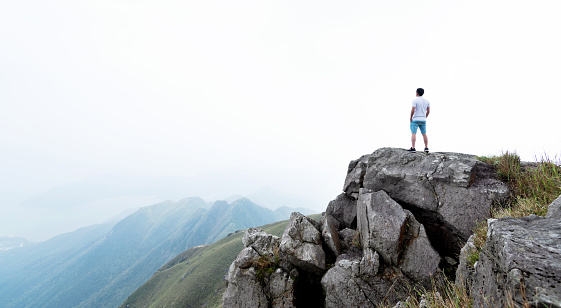 Man standing on the top of mountain.
