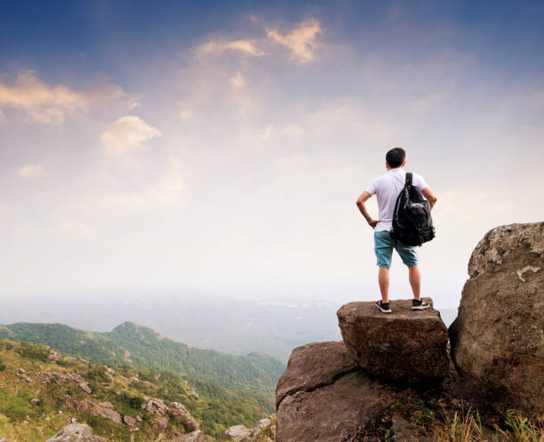 istock Man backpacker on the top of mountain 1219763904
