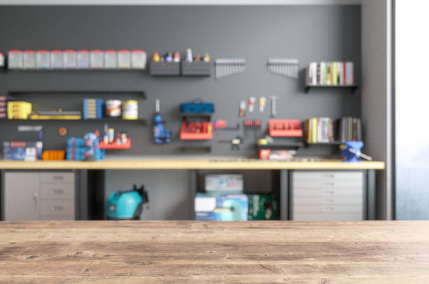 Empty Wooden Table Top With Blur Garage Interior Empty Wooden Table Top With Blur Garage Interior auto repair shop stock pictures, royalty-free photos & images