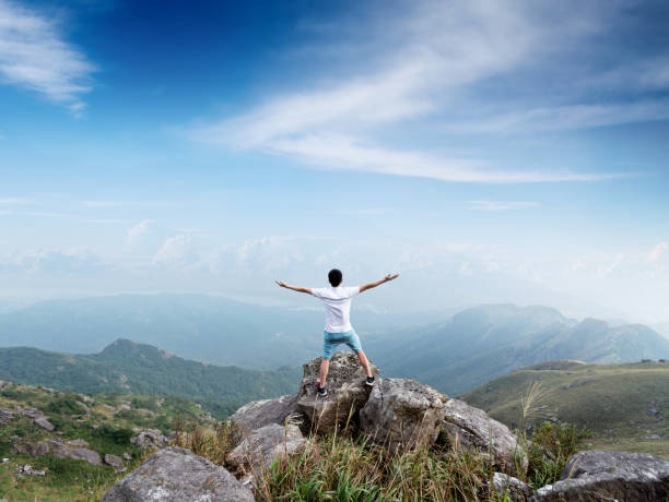 istock Man on the top of mountain 1219767813