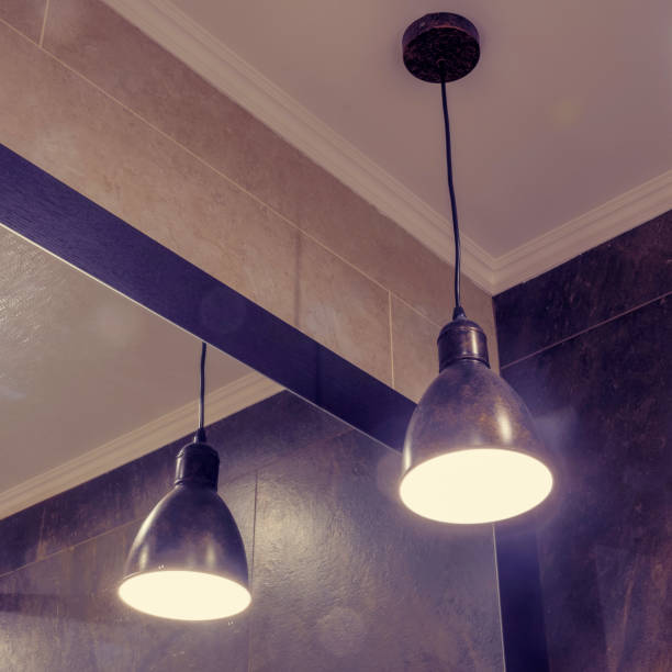 istock Loft industrial ceiling lamp hanging from a warehouse roof with mirror 1219768061