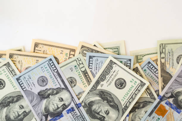 istock Side frame of different dollar cuperas randomly lie on a white background. Concept business, monetary fund. 1219768171