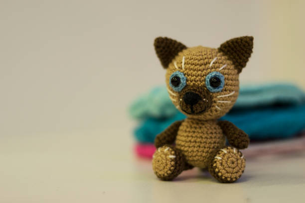 istock Amigurumi brown cat sitting on a white background. Needlework concept. 1219768325