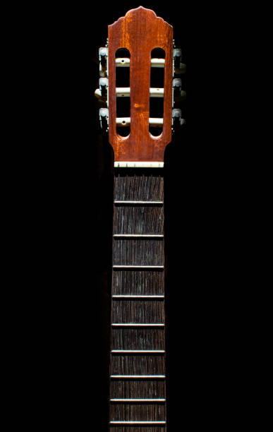 istock Guitar neck without strings isolated on black background. Details of a guitar, abstract background. 1219768520