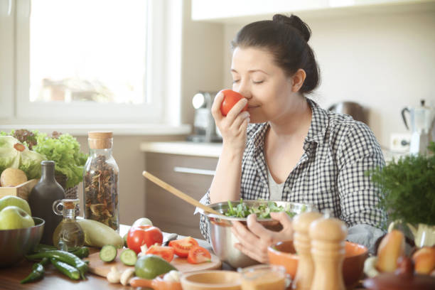 beautiful woman in the kitchen preparing food from fresh vegetables