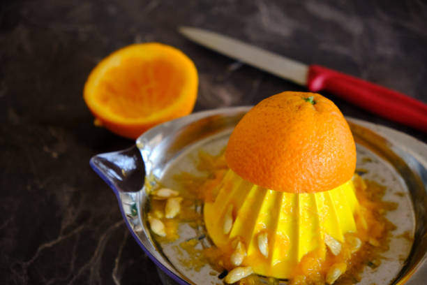 istock Orange Juice, Vitamin C Boost, Freshly hand juiced fruit juice. Half cut oranges 1219769307