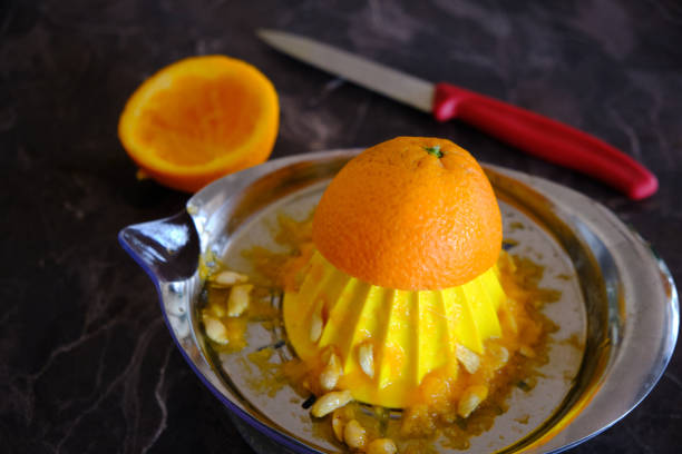 istock Orange Juice, Vitamin C Boost, Freshly hand juiced fruit juice. Half cut oranges 1219769588