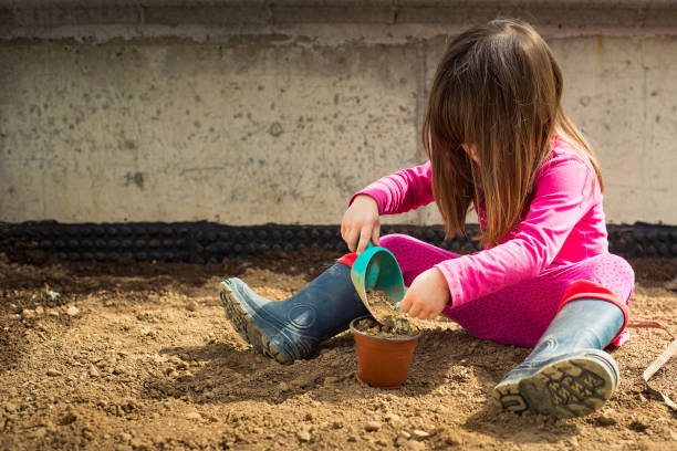 istock Child playing gardening during covid-19 lockdown. 1219769693