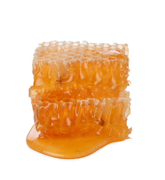 istock Honeycomb isolated single piece with liquid honey on white background 1219769790