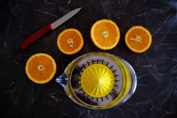 istock Orange Juice, Vitamin C Boost, Freshly hand juiced fruit juice. Half cut oranges 1219769906