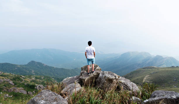 istock Man standing on the top of mountain 1219770528