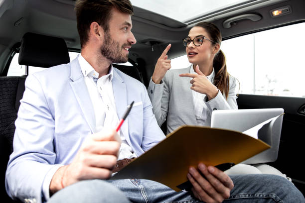 istock Young business people working together while traveling by a car. 1219771369