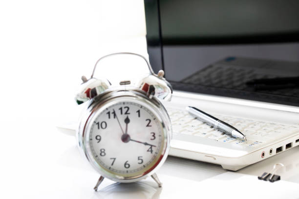 istock Business concept with laptop and desk clock 1219771410