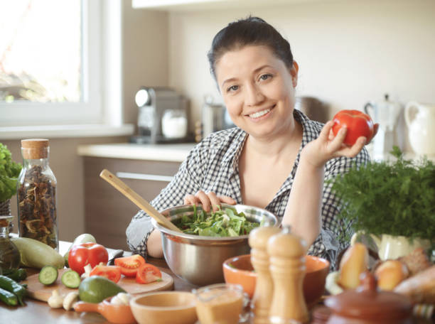 istock woman in the kitchen preparing food 1219772169