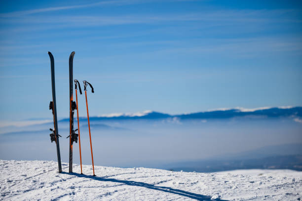 istock Skies in snow at mountain top 1219774575
