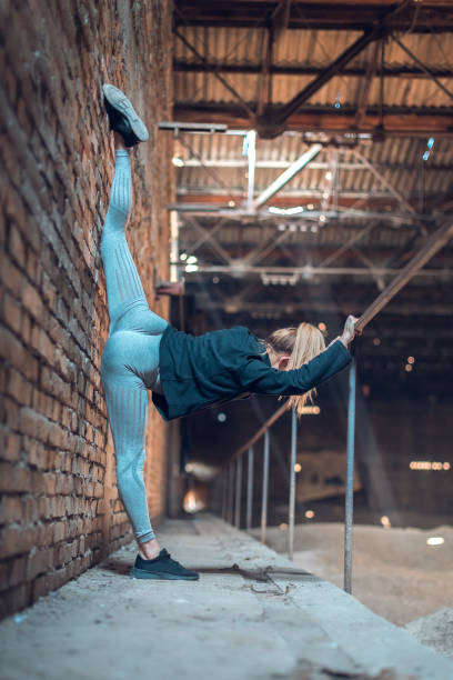 istock flexible young woman lifting leg extremely high 1219775499