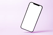 Smartphone mock up, phone with blank screen and shadow isolated on purple background. Modern technologies social networks and applications. Symbol of lightness freshness airiness. Copy space