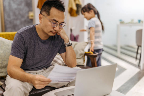 istock Worried man looking at bill 1219775648