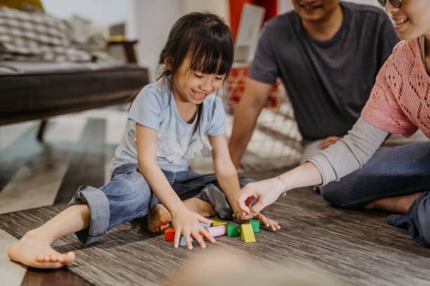 istock Parents playing toy blocks with daughter 1219775816