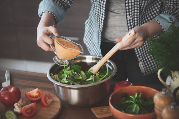 istock woman in the kitchen preparing food 1219780006