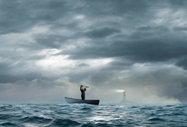 istock Businesswoman Searches For Lighthouse While Stranded On Boat 1219780367