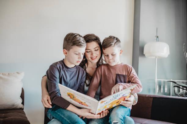 istock Mother reading a book to her sons 1219781197