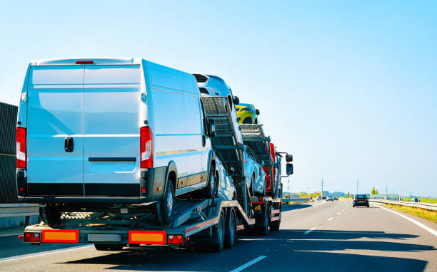 Truck carrier with mini vans at road of Slovenia Minivans Car carrier transporter truck in road. Mini vans Auto vehicles hauler on driveway. European transport logistics at haulage work transportation. Heavy haul trailer with tow on highway. car transporter truck small car stock pictures, royalty-free photos & images