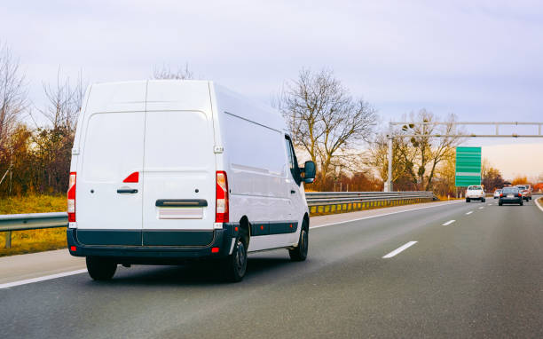 istock White Minivan on road on driveway van transport 1219781834