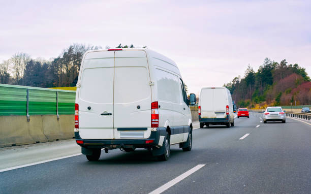 istock White Minivans in road European van transport 1219781864