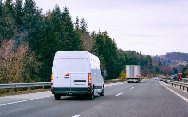 istock White Minivans on road van transport logistics 1219781874