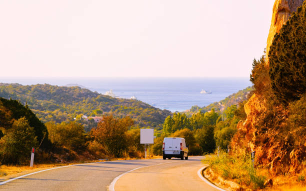 istock Mini van on road in street in Sardinia 1219782069