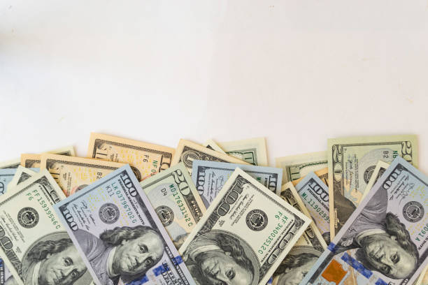 istock Side frame of different dollar cuperas randomly lie on a white background. Concept business, monetary fund. 1219782105