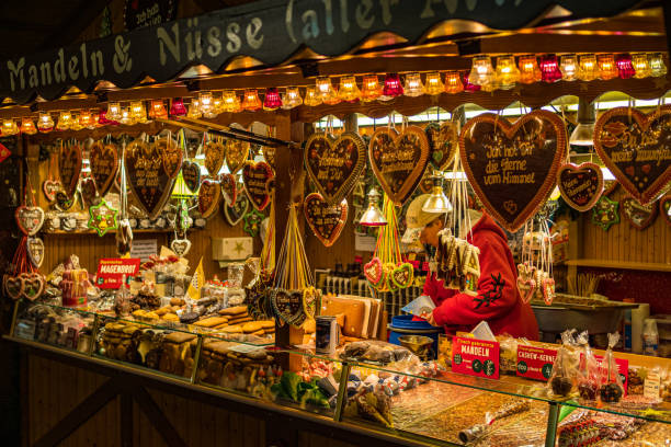 Heidelberg, Germany - December 2019: Booth on the Christmas market selling sweets Heidelberg, Germany - December 2019: Booth on the Christmas market selling sweets heidelberg germany stock pictures, royalty-free photos & images